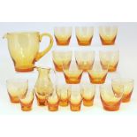 Whitefriars amber glass water jug, eleven glasses and six small glasses, together with a similar