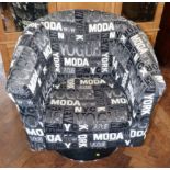 Modern swivel arm chair upholstered in black and white bearing the symbols "Vogue" "Today" and "