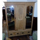 Stripped oak Art Nouveau style double mirror-door wardrobe with two drawers to base. Unfortunately