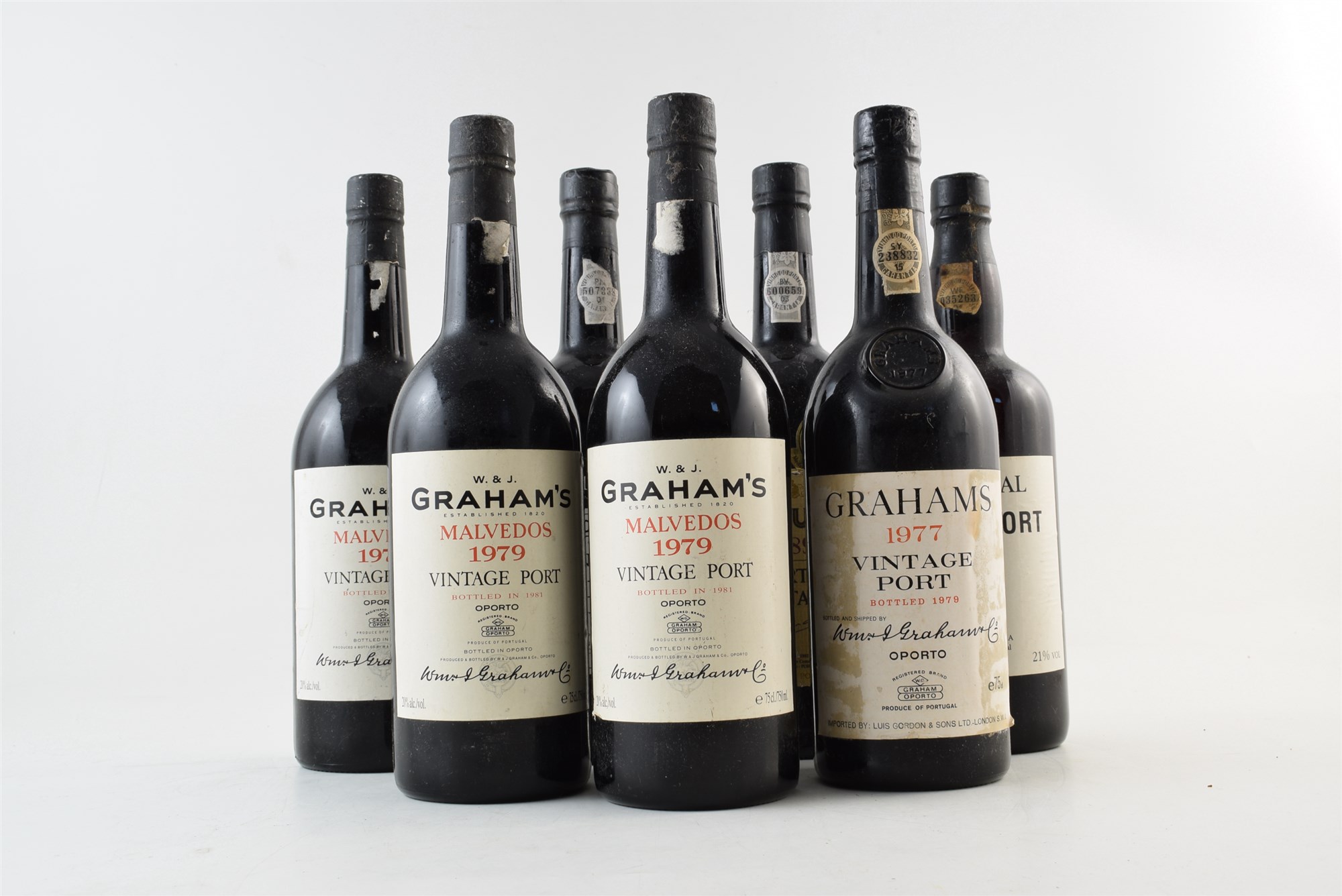 Seven bottles of port to include: 3 x bottles of Grahams Malvedos Vintage Port 1979. 1 x bottle