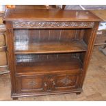 A reproduction oak open bookcase with two carved panel doors to base, 84cm wide Unfortunately we are