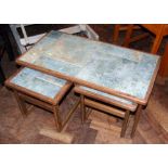 A nest of three teak tables inset with tile Unfortunately we are not doing condition reports on this