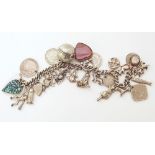 Silver charm bracelet with assorted silver charms Unfortunately we are not doing condition reports