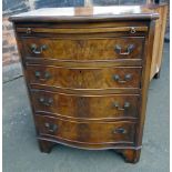 A reproduction walnut serpentine fronted chest of four drawers with dressing slide Unfortunately