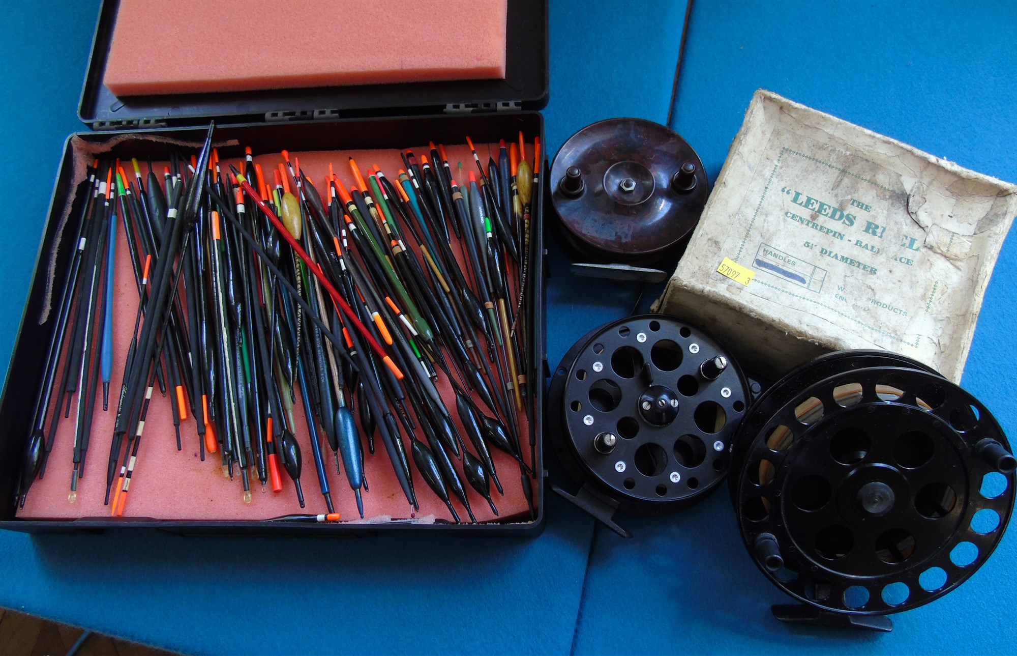 Boxed "The Leeds Reel" Shakespeare Black Eagle centre pin reel, ELO Bakelite reel and a box of