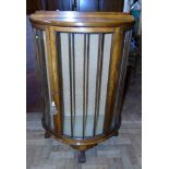 Early 20th century walnut bow-fronted display cabinet on ball-and-claw feet, 75cm wide.