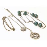 Four assorted silver necklaces, one comprising silver and turquoise charms, one with locket pendants