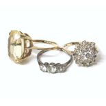 Three assorted ladies' rings including a 9ct ring set with assorted white stones, and a three-