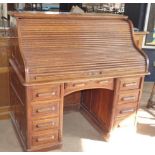 Early 20th century twin-pedestal roll-top desk, 126cm wide with fitted interior and nine drawers.