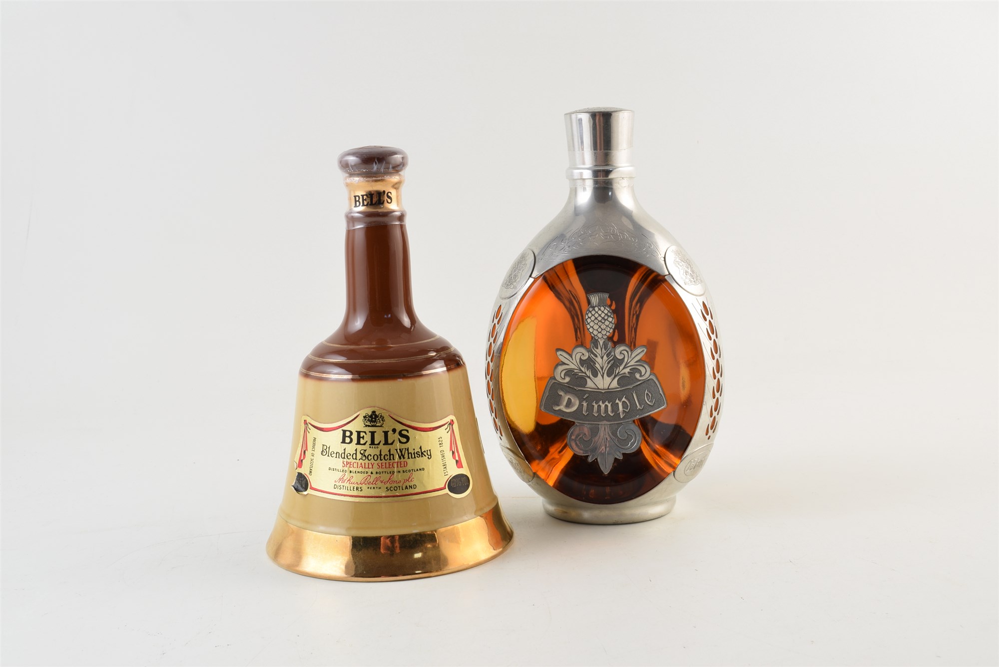 Dimple Haig sealed whiskey in class and pewter decanter also a Bells 37.5cl sealed decanter