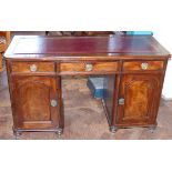 A Victorian mahogany twin pedestal desk with inset red leather top enclosing three frieze drawers