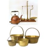 A set of brass balance scales complete with five graduated weights, a vintage copper kettle and four