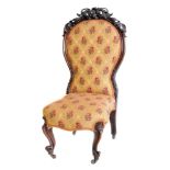 Victorian walnut framed nursing chair, spoon-back with pierced and carved cresting rail, upholstered