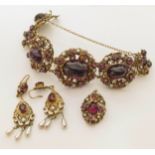 A vintage set of jewellery, to include a 5-stone purple paste bracelet with floral filigree, and a