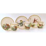 Three Royal Worcester cups and saucers painted with birds (birds missmatching on one set)