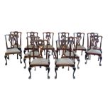 Set of twelve mid 19th century mahogany dining chairs, comprising ten singles and two open arm