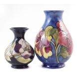 Two Moorcroft vases, decorated with Hibiscus and Magnolia patterns, one with box, the Magnolia