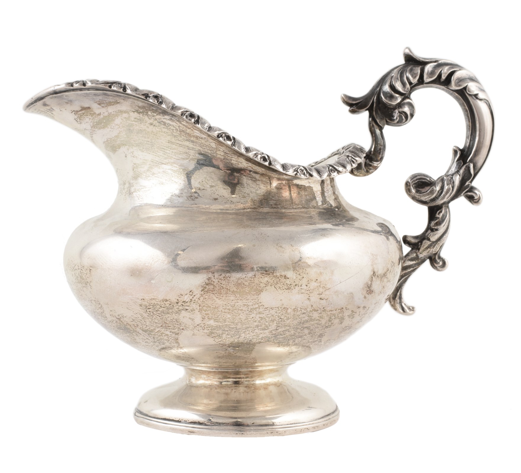 A George III silver milk jug , plain polished baluster form body with gilt interior, acanthus scroll