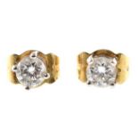 Pair of diamond solitaire 18ct gold stud earrings , the two round brilliant cut diamonds with a