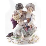 Meissen figure group, modelled as a girl and boy with lamb on scrolled base, incised 812,