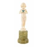 An Art Deco Ivory and Onyx Figure by F. Priess. The carved ivory figure figure of a girl holding a
