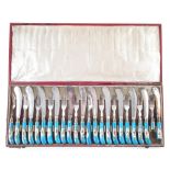Cased set of twelve porcelain knives and forks, painted in the Sevres style with exotic birds within
