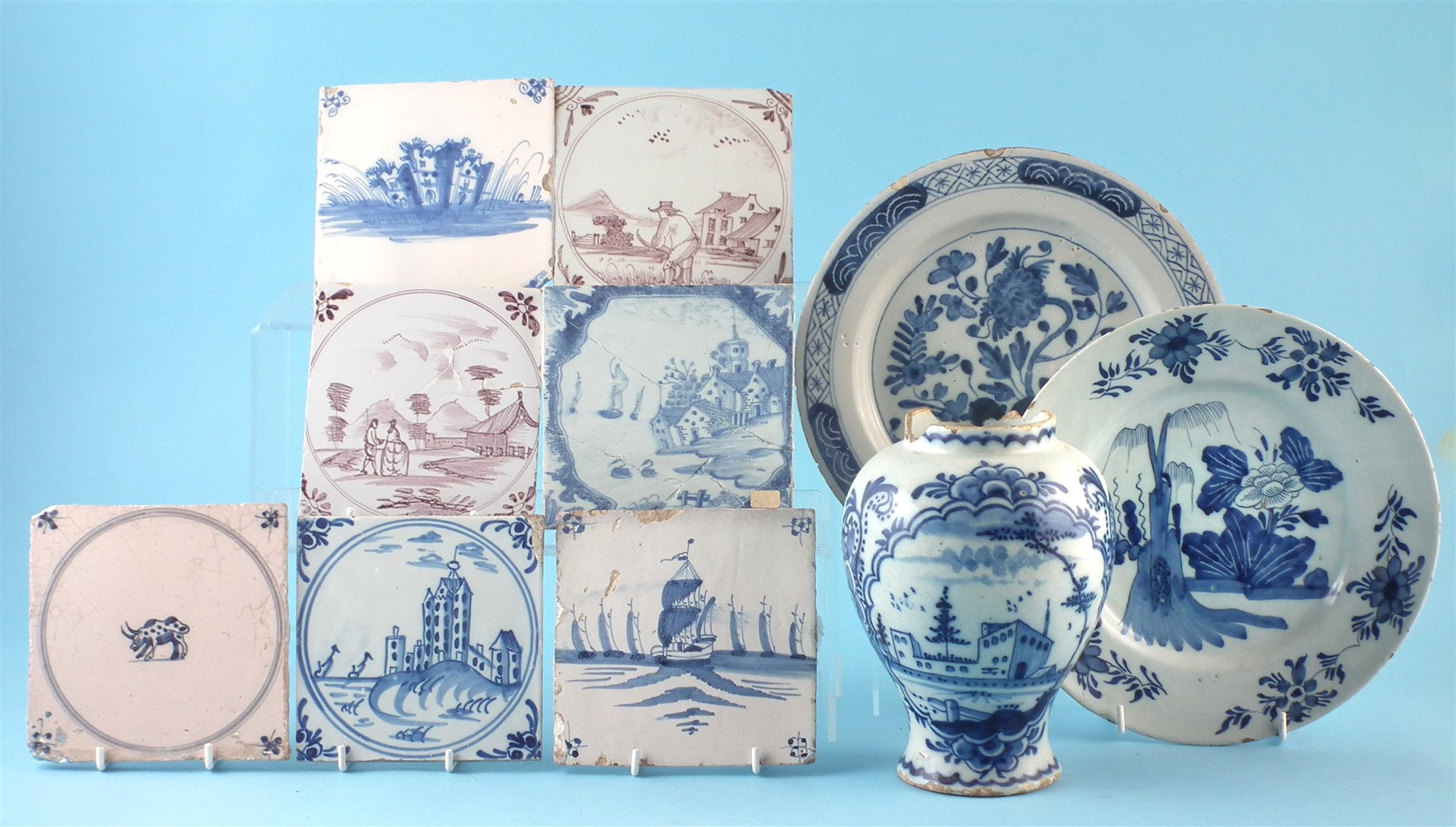 Group of Delft ware, to include five blue and white tiles and two others decorated in manganese, two