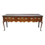 George III oak and mahogany cross-banded dresser base, rectangular top with ogee mould above three