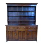 George III oak dresser, top section with ogee cornice above three fixed shelves with planked back,