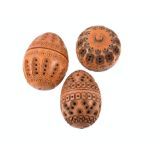 Three pierced and carved coquilla nuts. Two egg shaped, one apple shaped. With screw tops. Largest