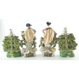 Pair of Samson 'Chelsea' sheep candlestick figures, modelled in front of floral bocages, spurious