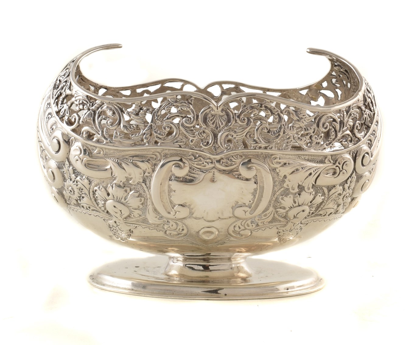 Victorian silver bon-bon dish with pierced and repousee scrolling decoration, on oval pedestal foot,