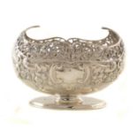 Victorian silver bon-bon dish with pierced and repousee scrolling decoration, on oval pedestal foot,