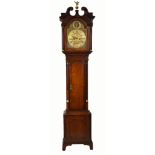 A 19th century mahogany longcase clock with glancing eyes. The double swan neck pediment with
