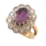 Amethyst and diamond 18ct gold cluster ring , central oval amethyst measuring approx. 10mm x 8mm,