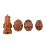 Four pierced and carved coquilla nuts. Three egg shaped and one turret shaped. Largest is 10cm.