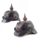 Two German / Prussian Pickelhaube helmets, each with brass spike eagle plate, national cockades