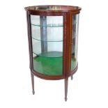 Edwardian mahogany vitrine, the cabinet of circular section, top with glazed bevelled single