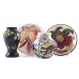 Four pieces of Moorcroft , decorated with Chicory, Frangipani, Anna Lily, and Finches patterns,
