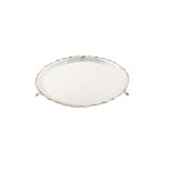 Circular silver tray by William Hutton & Sons , plain polished circular body with waved border on
