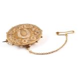 A Victorian 9ct yellow gold good luck oval brooch, oval body measuring approx. 33mm x 25mm,