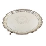 Edwardian circular silver tray , plain polished body with Chippendale border on 3 paw feet,
