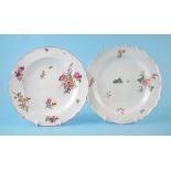 Two Chelsea plates circa 1750-1760, painted with flowers, one of red anchor period, the other of