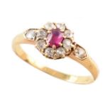 Circa 1900 ruby and diamond round cluster 18ct gold ring with diamond set shoulders , central ruby