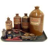 Three stone jars of Stephen's Scarlet Writing Fluids, candle wax and two cast iron ink/pen stands.