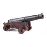 Small 19th century bronze cannon, the barrel engraved 12 Pr. 1 In scale, mounted on mahogany naval