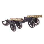 Pair of brass display cannons, with cast iron carriages, (2) 47cm long