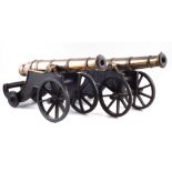 Two similar bronze model cannons, on cast iron bases, late 19th century, (2) barrel length 44.5cm,