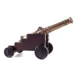 19th century bronze model cannon , with dolphin handles mounted on mahogany naval carriage, barrel