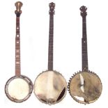 Three five string banjos, one by Monarch, another by John Grey, all with period cases, one leather